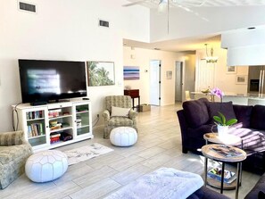 Relax in a cozy seating area with a flat-screen TV, comfortable sofa, and a stylish coffee table.