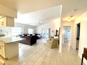 Relax in this spacious living area with a large kitchen, central island, and comfortable seating.