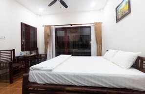 A room with a bed, a desk, and a chair.