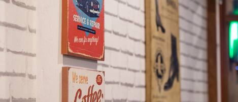 A wall with signs advertising 'Classic Garage Service & Repair' and 'We serve Coffee'.
