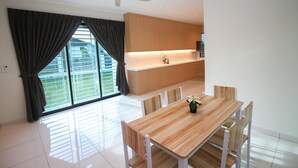 A modern kitchen with wooden cabinets and a white countertop. - Alheri Austin Johor (Johor Bahru)