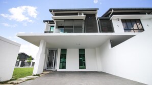 A modern two-story building with a flat roof, large windows, and a covered entrance area. - Alheri Austin Johor (Johor Bahru)