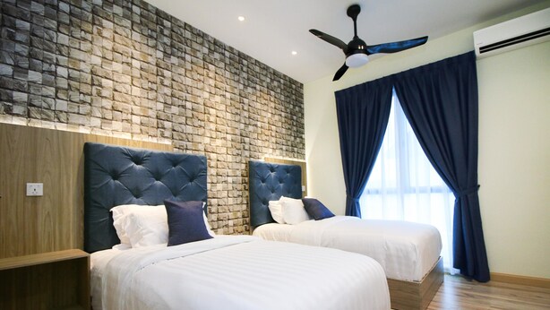A hotel room with two beds, a brick-patterned wall, a ceiling fan, and a large window with curtains. - Alheri Austin Johor (Johor Bahru)