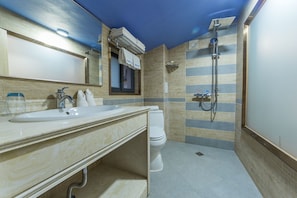 A modern bathroom with a sink, mirror, and toilet.