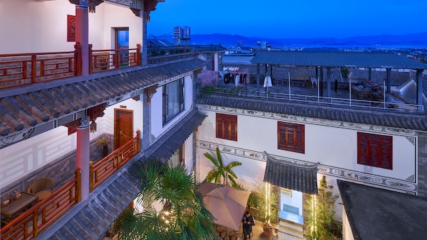 A traditional multi-story building with ornate architectural details, including tiled roofs and wooden railings.