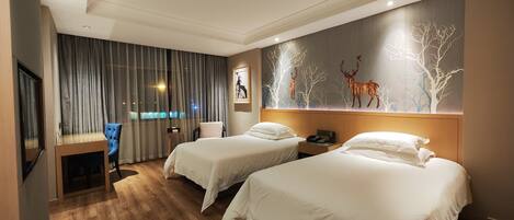 A hotel room with two beds, a desk, and a chair. There is a wall with a deer mural.