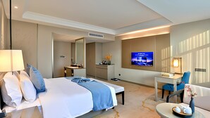 A modern hotel room with a large bed, a desk, a TV, and a bathroom. - Byland Star Hotel (Jinhua)