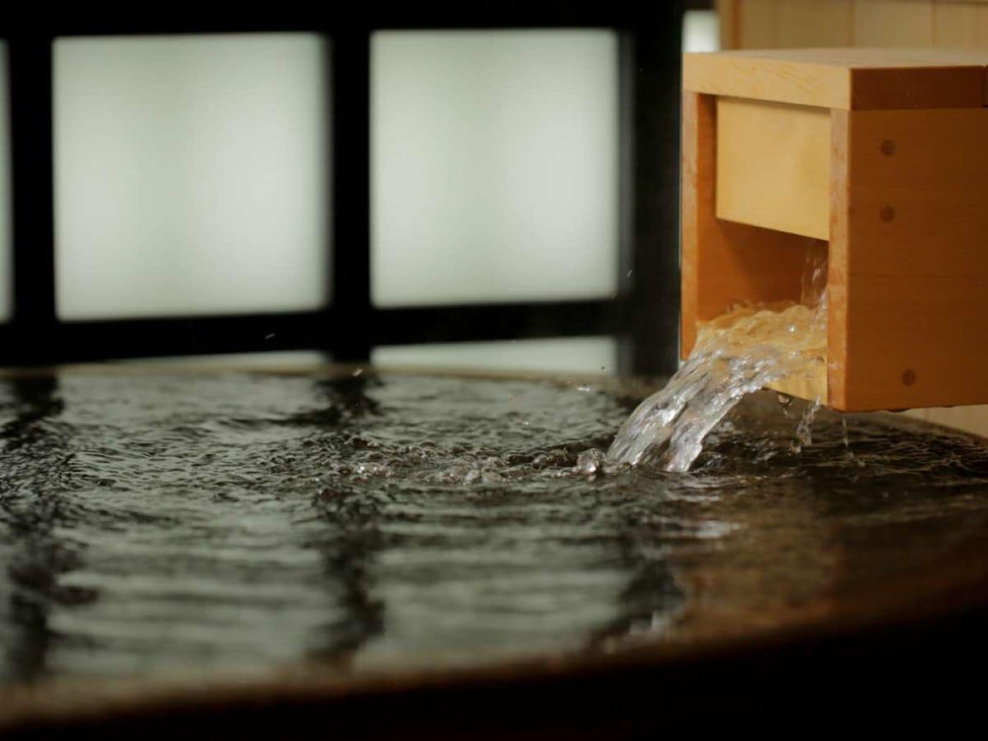 A wooden structure with water flowing from it.