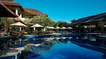 Una piscina al aire libre, tumbonas