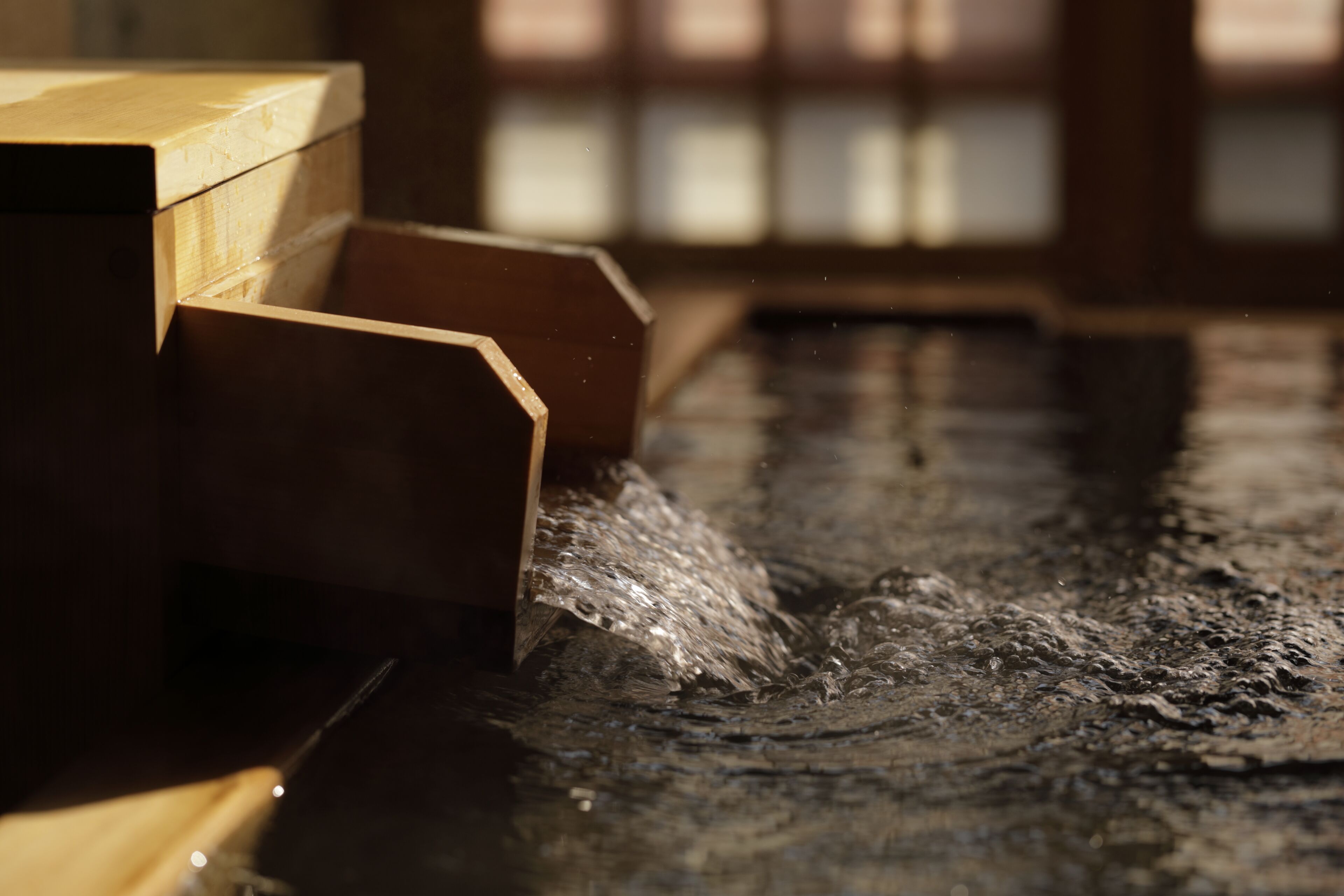 Une structure en bois agrémentée d’un élément aquatique, peut-être une fontaine ou un jeu d’eau.