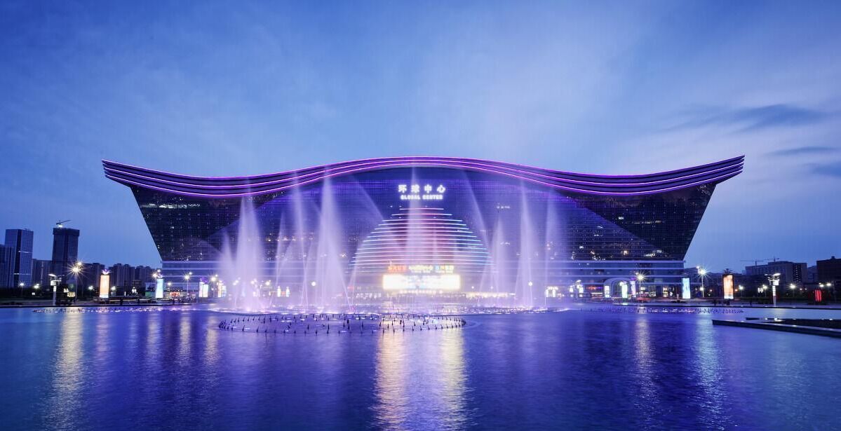 A modern building with a unique curved roof and a large central atrium.