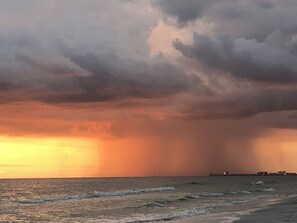 A coastal sunset with overcast skies.
