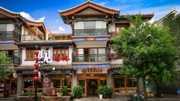 A traditional building with multiple levels, balconies, and a sign with Chinese characters. - Floral Hotel Libo Meet Inn (Qiannan)