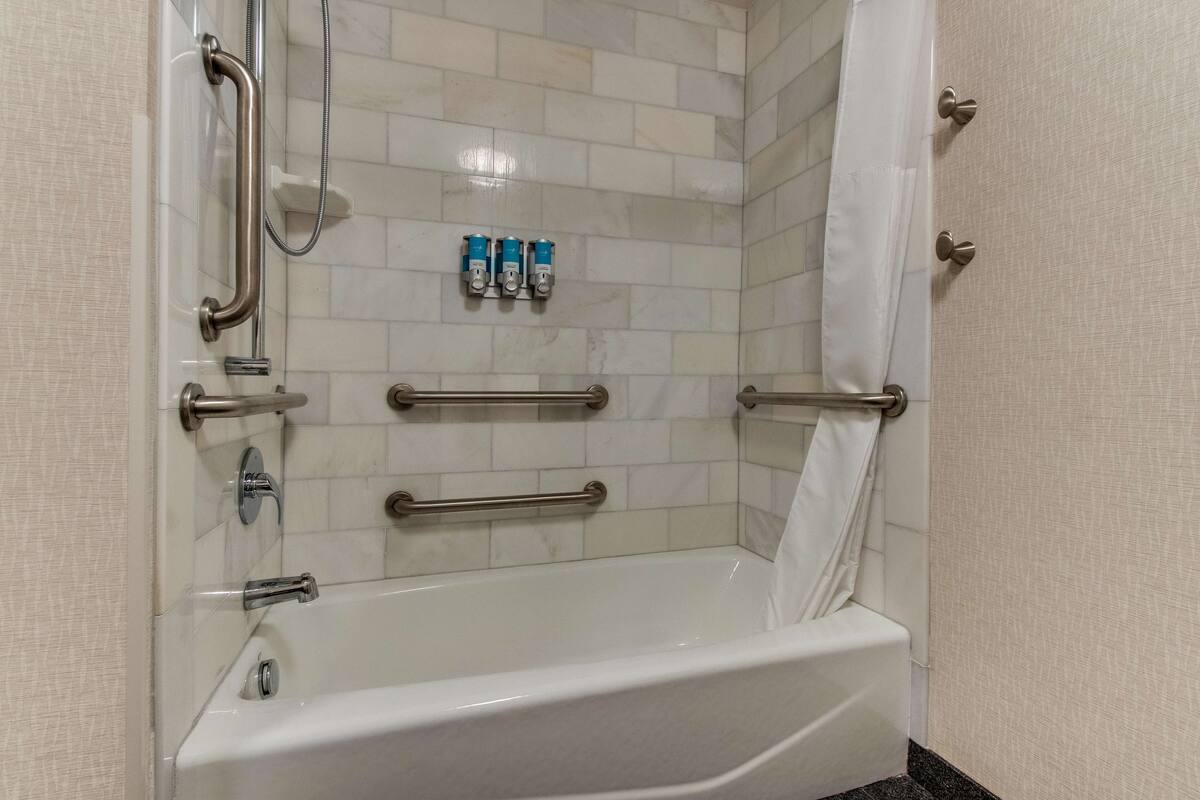 deluxe room, 2 queen beds, accessible, refrigerator & microwave (tub) | bathroom | shower, free toiletries, hair dryer, towels