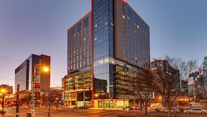 A multi-story hotel with a prominent 'DRURY' sign at the top, large glass windows, and a modern architectural design. - Drury Plaza Hotel Nashville Downtown (Nashville)