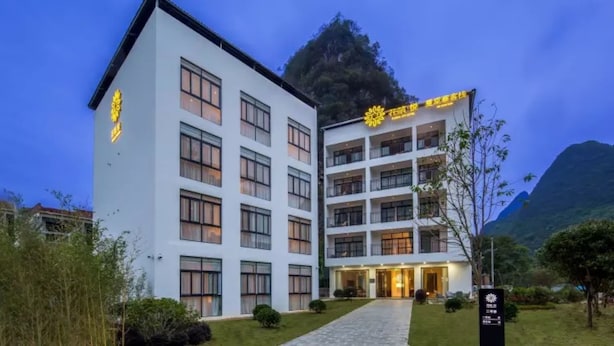 A multi-story hotel with a white exterior and balconies. - Floral Hotel Yangshuo Xiatangzhai (Guilin)