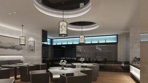 A modern restaurant with a central dining area, high ceiling, and contemporary lighting fixtures. - Metropolo  Liyang Pingling West Road Hotel (Changzhou)