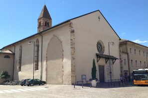 A church with a prominent bell tower and a large arched entrance. - Apartment Duomo (Bolzano)