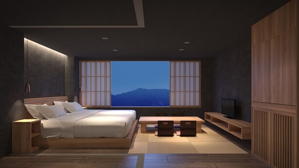 Une chambre moderne avec un grand lit, une télévision, un bureau en bois et une vue sur les montagnes par une grande fenêtre.