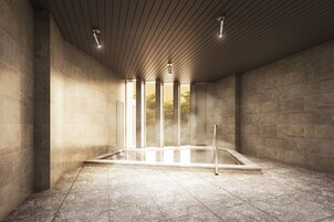 Un moderno espacio de spa con suelo de baldosas de piedra, techo de madera y una bañera de hidromasaje con cerramiento de vidrio.