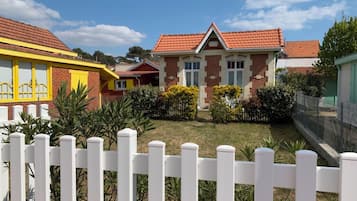 A residential area with houses featuring red-tiled roofs and brick facades.