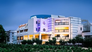 A multi-story hotel with a modern design, featuring balconies and a prominent entrance.