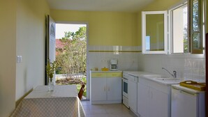 A compact kitchen with white cabinets, a sink, and a coffee maker. - PROHE MIREPOIX EXCEPTIONAL VIEW OF PYRENEES (Tréziers)