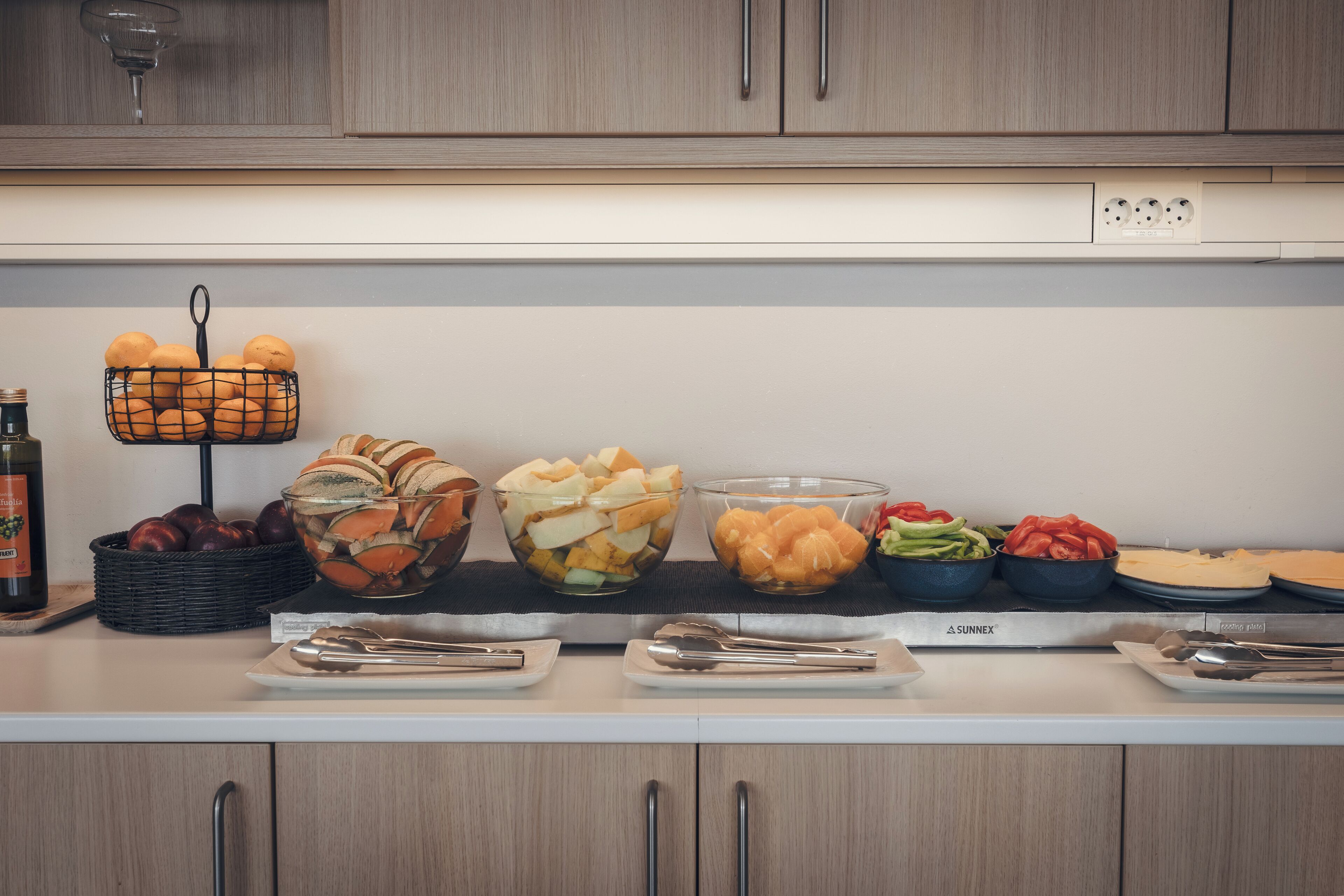 A kitchen counter with various food items and utensils.