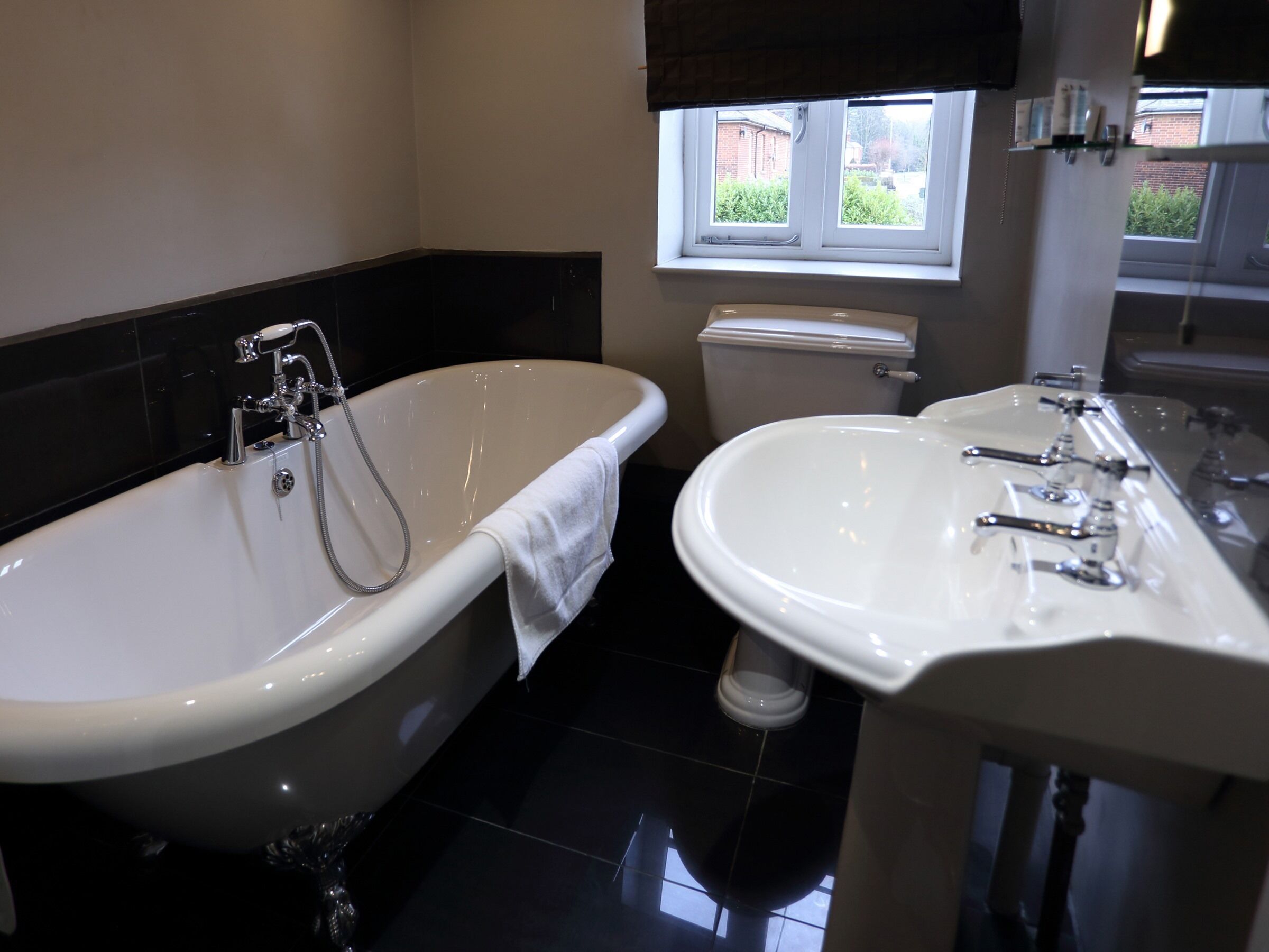 A bathroom with a freestanding bathtub, a toilet, and a sink.