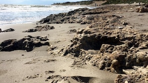 A rocky beach with waves crashing onto the shore. - Cabopino (Marbella)