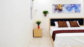 Un dormitorio con cama, mesita de noche y una obra de arte en la pared.