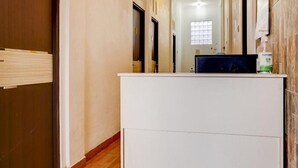 A hotel reception area with a reception desk, a window with blinds, and a door marked with the number 101. - Semata Wayang Syariah Homestay (Banjarbaru)
