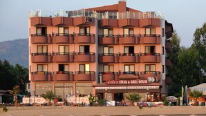 A multi-story hotel with a restaurant on the ground floor named "Lily's Steak & Grill House".