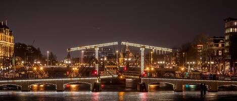 A nighttime view of a cityscape with illuminated bridges and buildings.