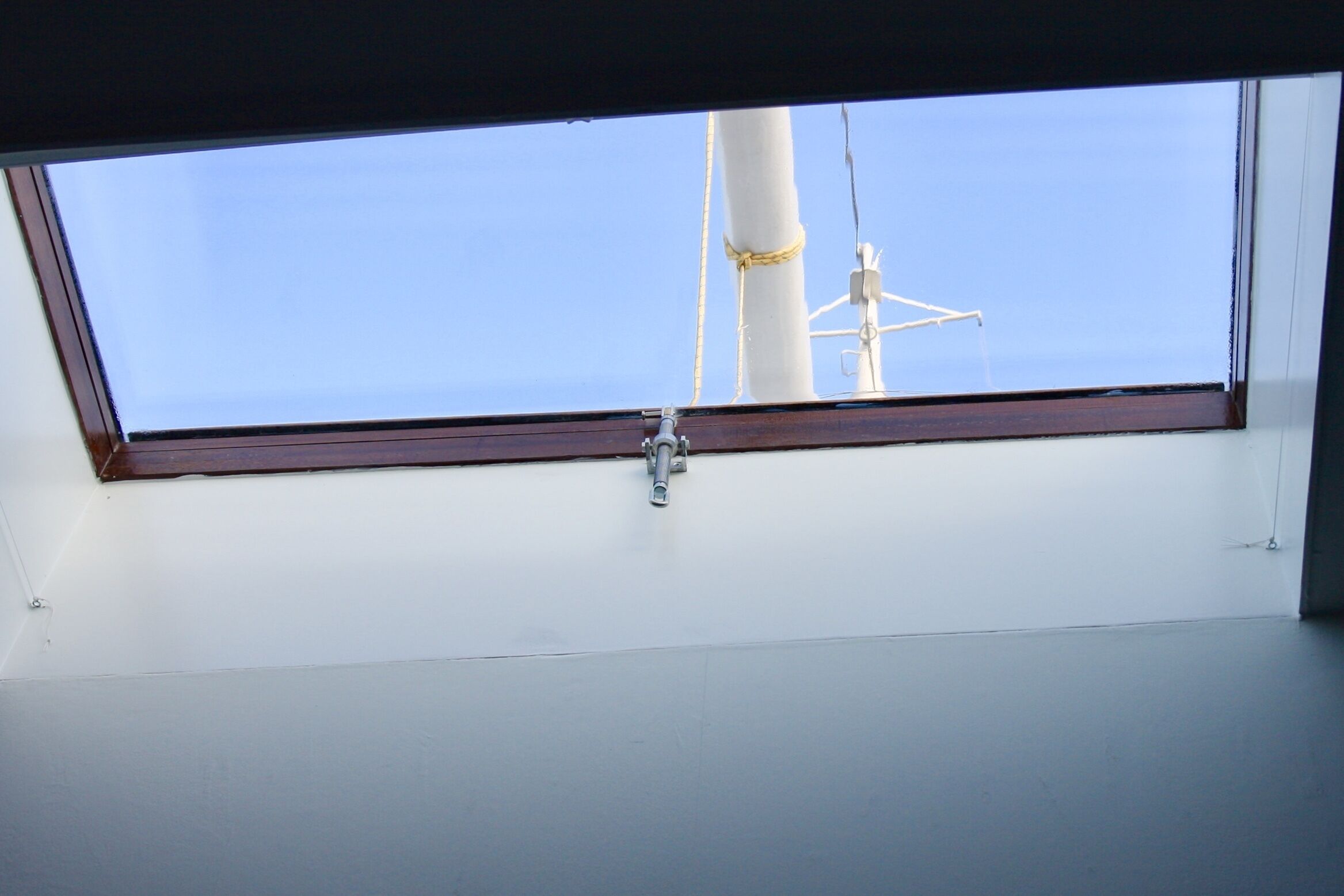 A skylight window with a metal latch.