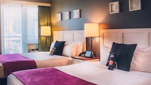 A hotel room with two beds, a nightstand with a lamp, and a window with curtains. - Pet-Friendly Stay | Ski Shuttle, Hot Tub + Sauna (Whistler)