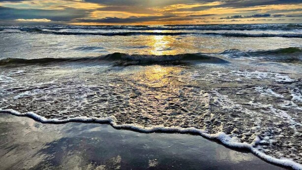 A beach with waves and a sunset. - Coco Beach Hotel on South Padre Island (South Padre Island)