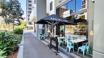 Relax in the shaded seating area of Milk Crate, where you can enjoy a meal.