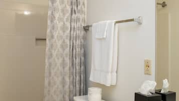 A bathroom with a toilet, sink, and shower curtain.