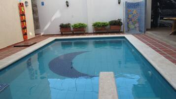 Outdoor pool, open 8:00 AM to 10:00 PM, pool loungers