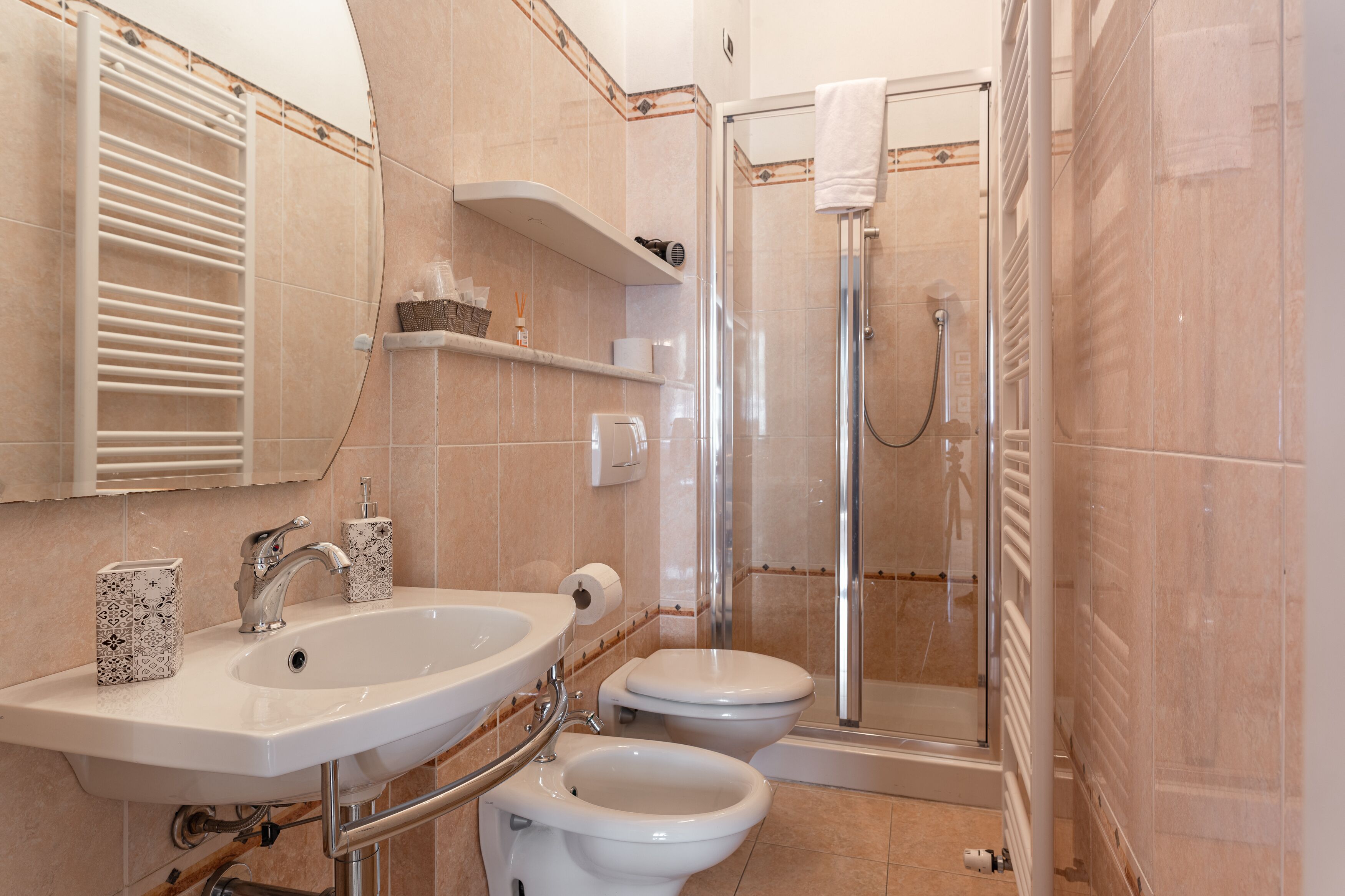 A bathroom with a sink, toilet, and shower.