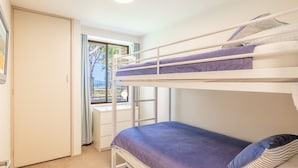 A bunk bed room with a window overlooking a beach. - Mistral Court 2, 17 Mistral Close - little beach water views & Wifi (Nelson Bay)