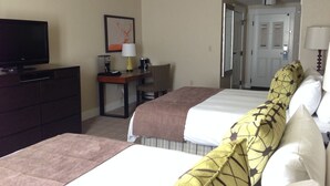 A hotel room with two beds, a television, a desk with a lamp, and a door leading to another room. - Spacious Room at The Marriott Grand Residence (South Lake Tahoe)