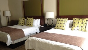 Two double beds with brown headboards, white linens, and patterned pillows. There are bedside tables with lamps and a telephone. - Spacious Room at The Marriott Grand Residence (South Lake Tahoe)