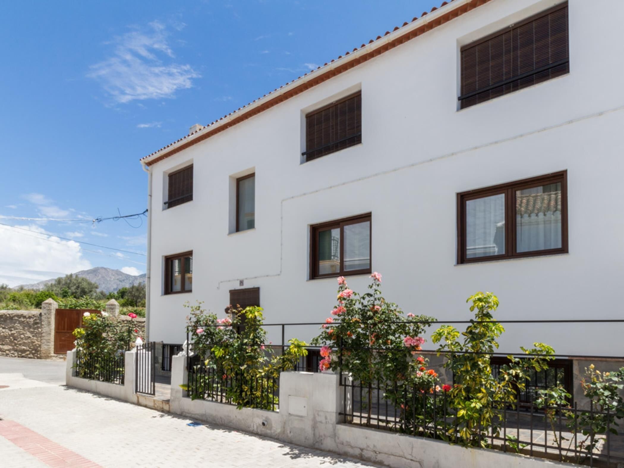 A white building with multiple windows and a balcony.