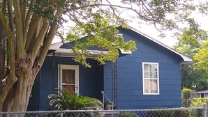 A single-story house with a dark blue exterior, a front door, and a small porch. - Charleston "Home-Away-from-Home" - Close to All Major Attractions! (North Charleston)