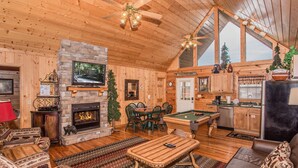 A cozy log cabin interior with a fireplace, pool table, and wooden furniture. - 🌲Dancing Bear Den🌄Mountain Views, Resort Pool & Hot Tub (Sevierville)