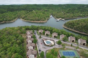 A residential area with a lake, a tennis court, and a boat dock. - 03-6 The Aerie Closest development to Silver Dollar City, Indoor/Outdoor Pool, Indoor Outdoor Splash Pad, Hot Tub & Workout Facility (Branson)