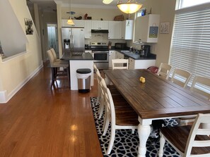 Enjoy cooking and dining in this well-equipped kitchen with a central island, oven, and microwave.
