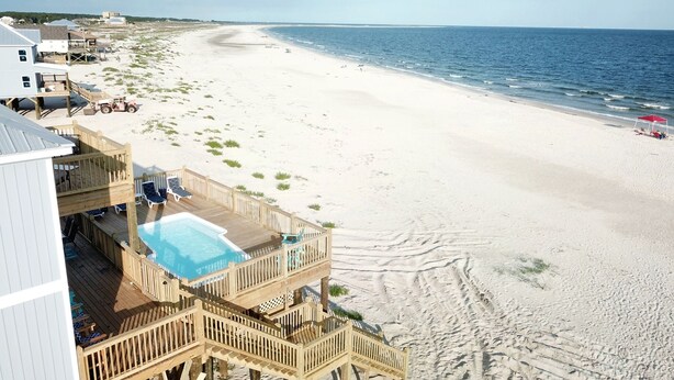 A beachside property with a wooden deck, a swimming pool, and a view of the ocean. - Gulf Front, Private Heated Pool, Pet Friendly, 2 Master Suites! – Island Time IV (Dauphin Island)
